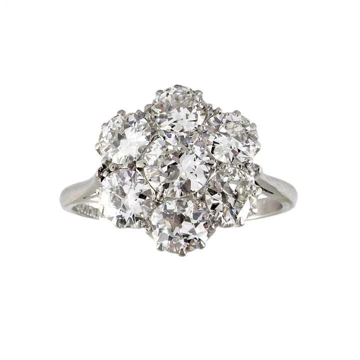 Mid-20th century diamond flowerhead cluster ring, c.1950, circular, with seven old round European cut diamonds, the largest to centre,